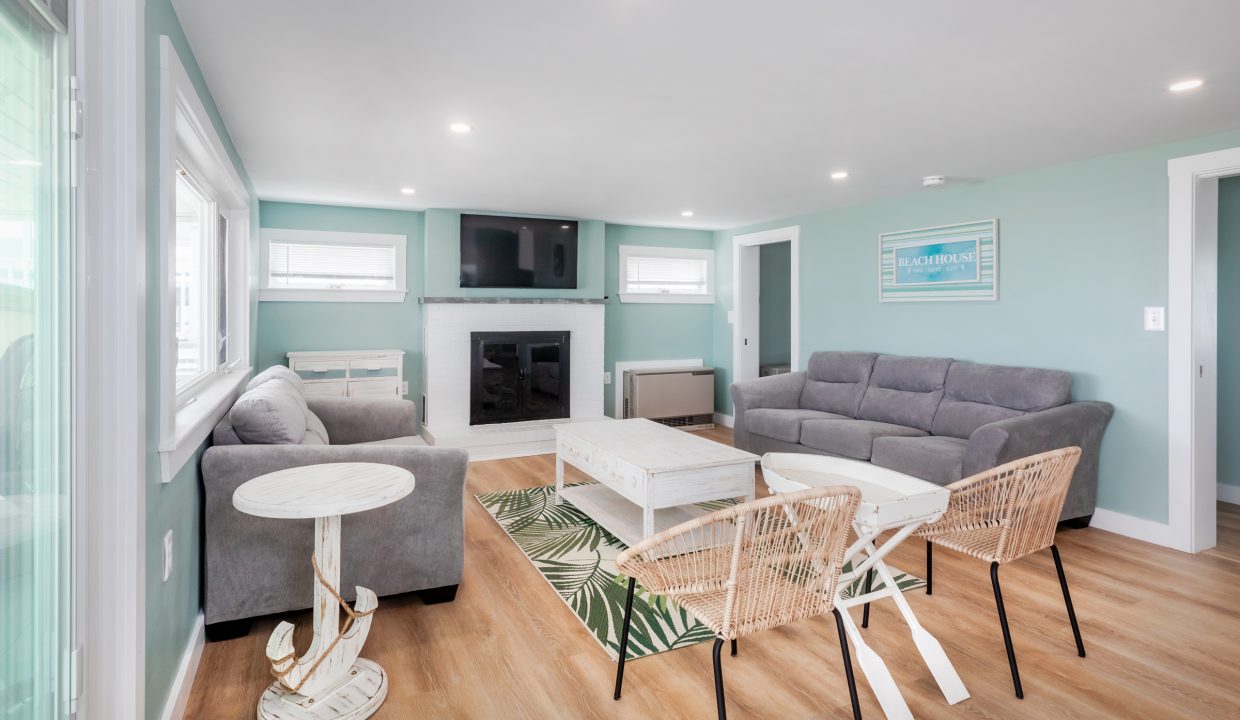 a living room with blue walls and white furniture.