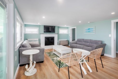 a living room with blue walls and white furniture.