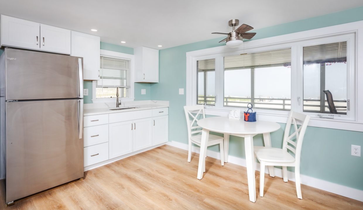 a kitchen with blue walls and a table and chairs.