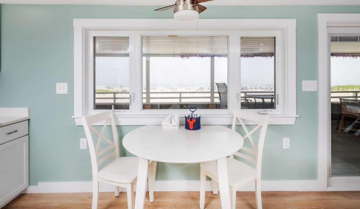 a kitchen with a white table and chairs.