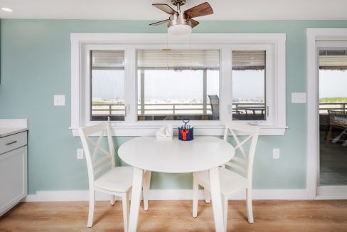 a kitchen with a white table and chairs.