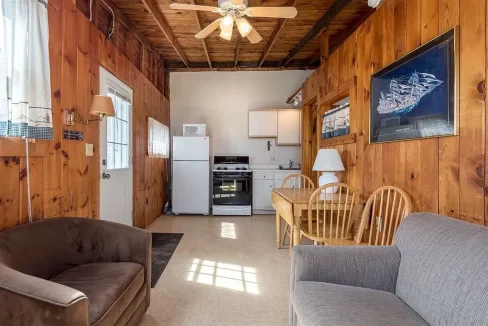 a living room filled with furniture and a ceiling fan.