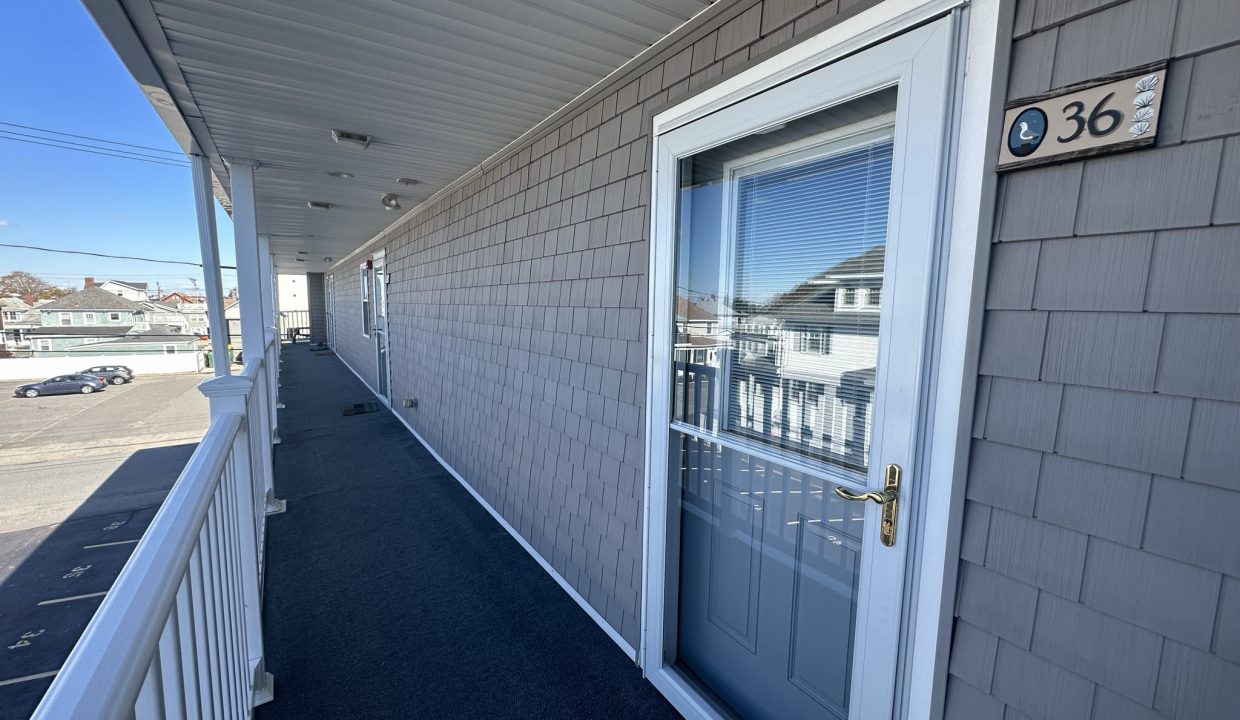 a house with a white door and a blue carpet.