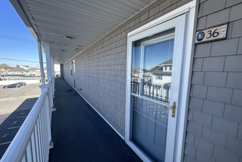 a house with a white door and a blue carpet.