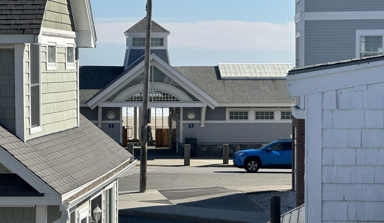 a blue car is parked in front of a building.