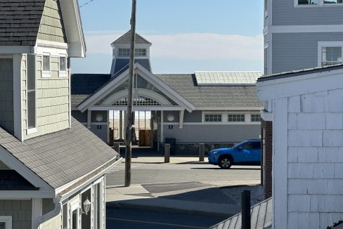 a blue car is parked in front of a building.