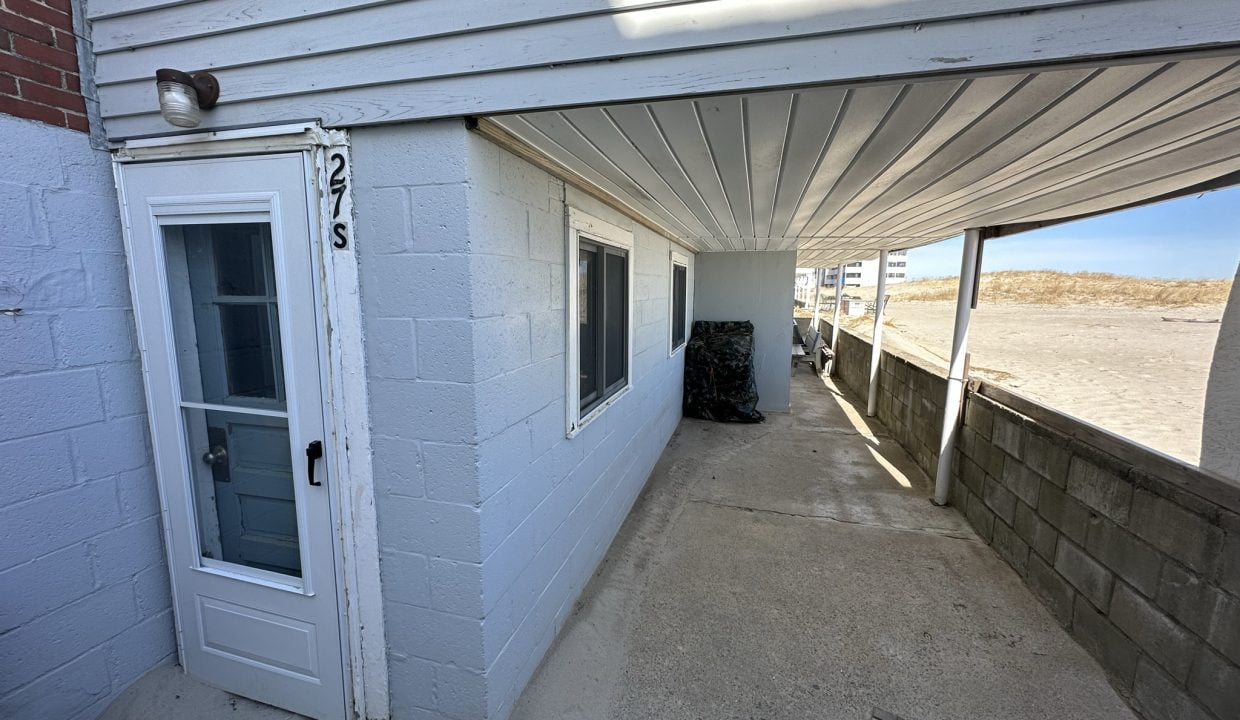 a white building with a white door and windows.