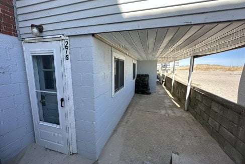a white building with a white door and windows.