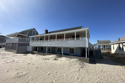 a house on the beach with a balcony.