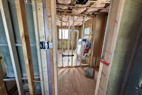 a room that is under construction with a lot of wood.