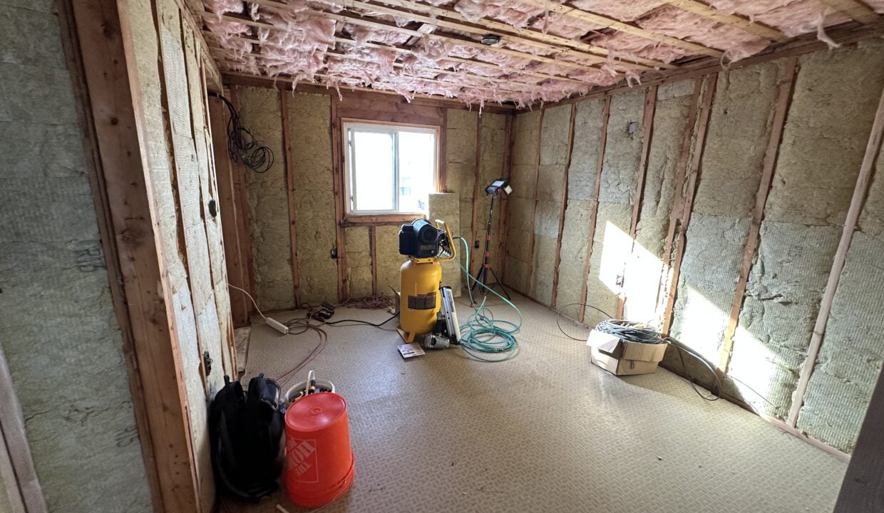 a room that is under construction with a vacuum.