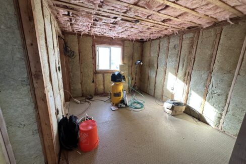 a room that is under construction with a vacuum.