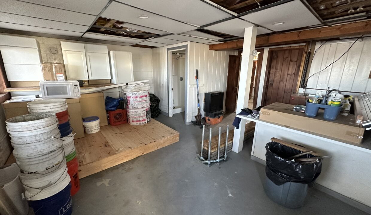a kitchen with a lot of junk on the floor.