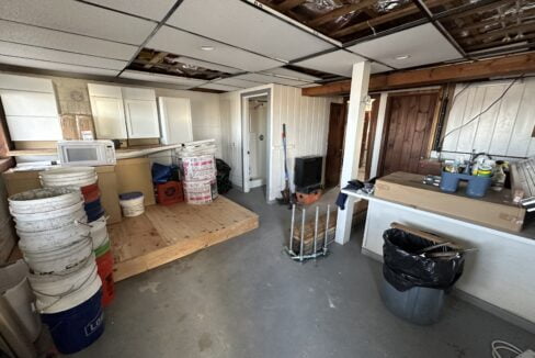 a kitchen with a lot of junk on the floor.
