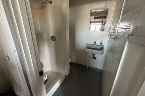 a bathroom with a sink and a shower.