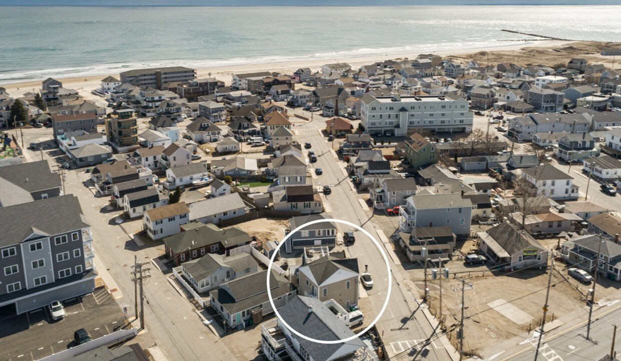 a bird's eye view of a neighborhood by the beach.