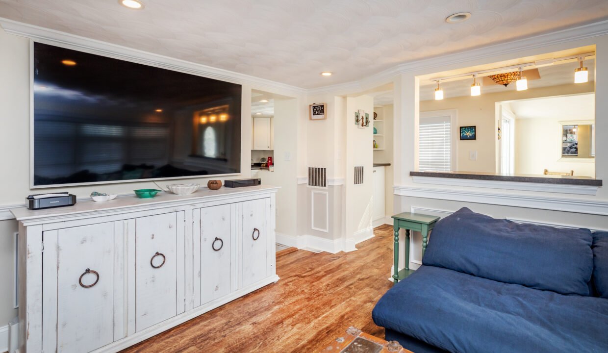 a large flat screen tv mounted to a wall in a living room.