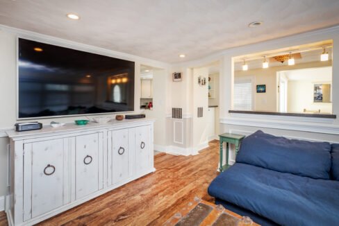 a large flat screen tv mounted to a wall in a living room.