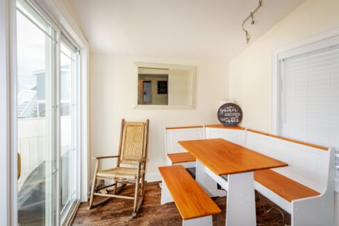 a room with a bench, table and a chair.