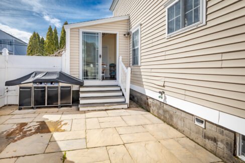 a house with a patio and steps leading to the front door.