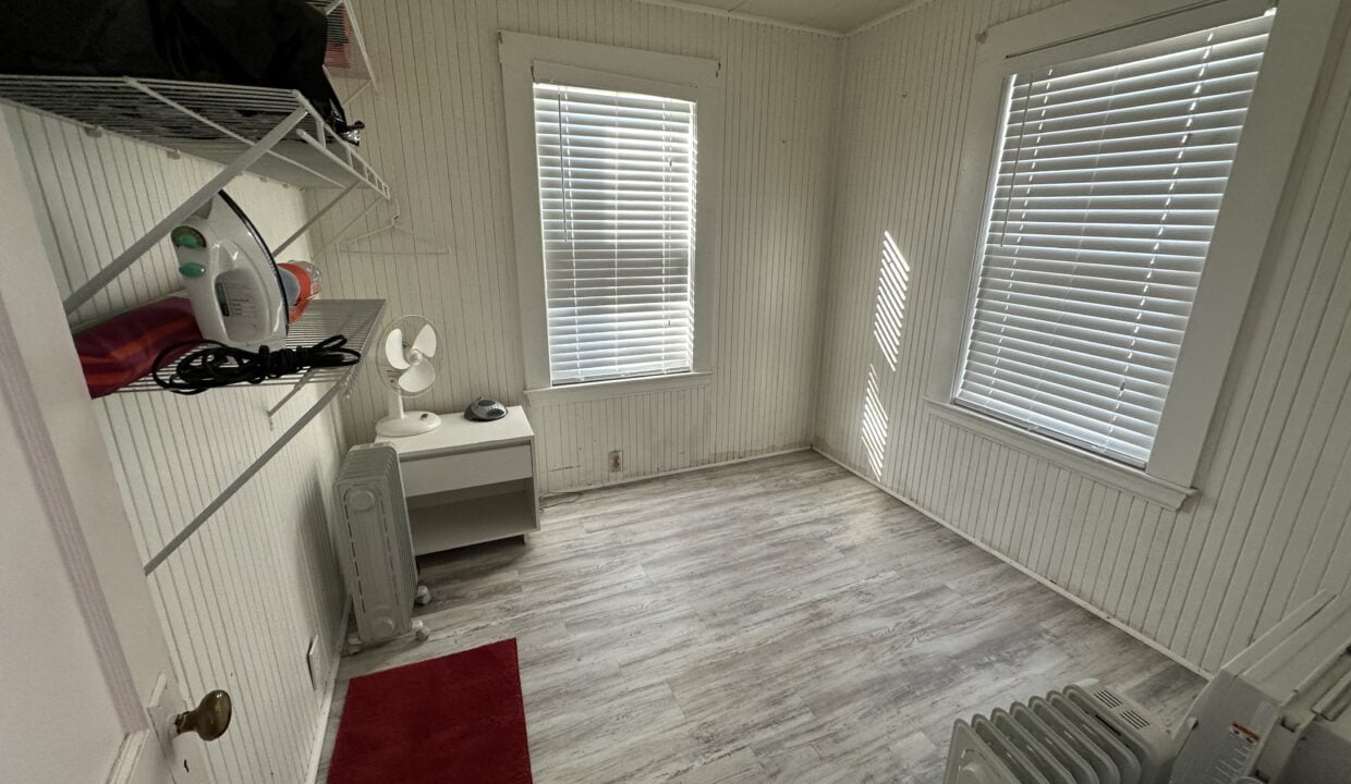 a room with a radiator, a radiator, a heater.