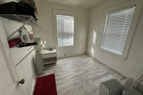 a room with a radiator, a radiator, a heater.
