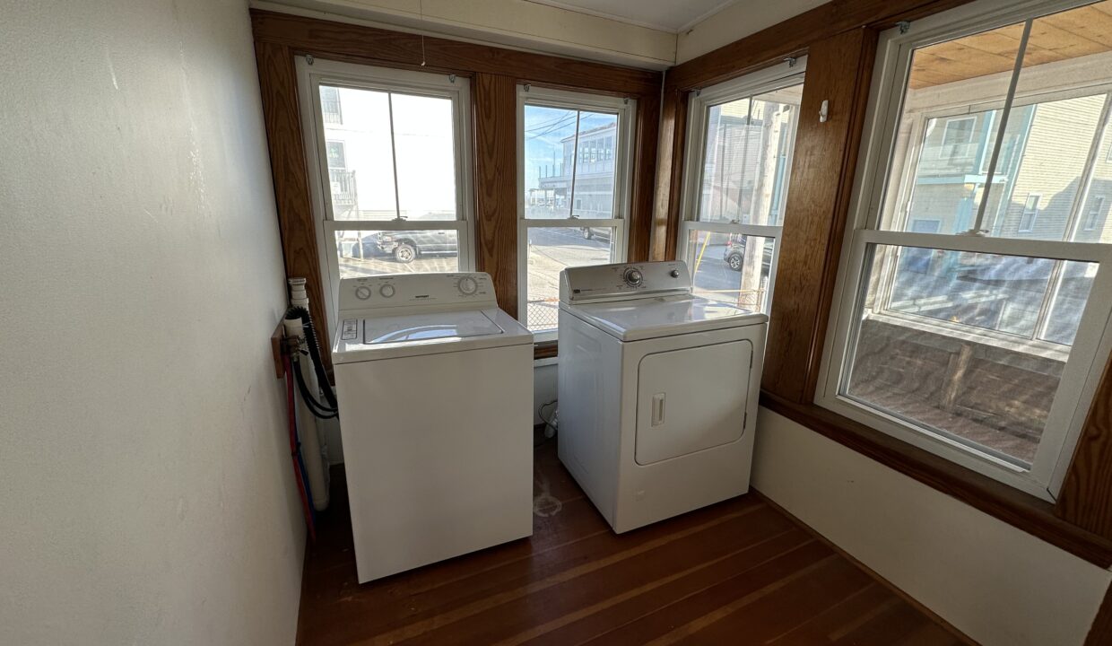 a washer and dryer sitting in a room next to a window.