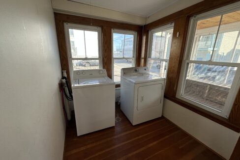 a washer and dryer sitting in a room next to a window.