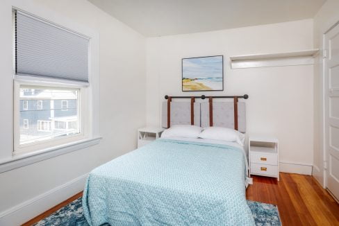 a small bedroom with a bed and a window.