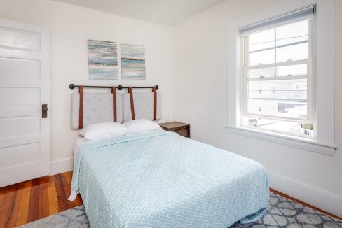 a small bedroom with a bed and a window.