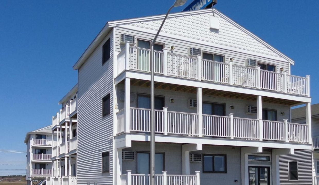 a white building with balconies and balconies on top of it.