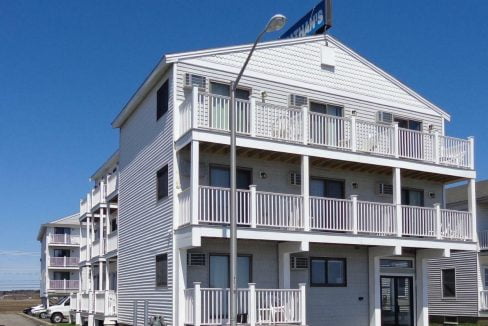 a white building with balconies and balconies on top of it.
