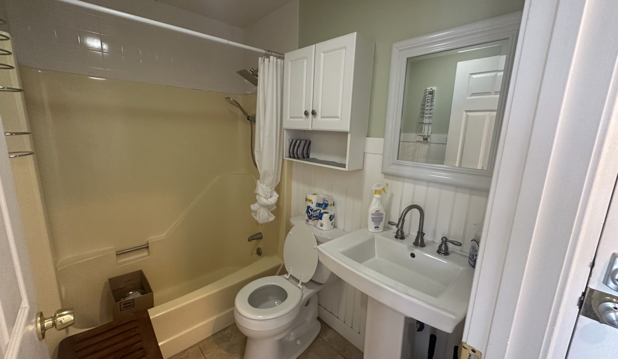 a bathroom with a sink, toilet, and bathtub.