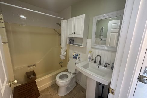 a bathroom with a sink, toilet, and bathtub.