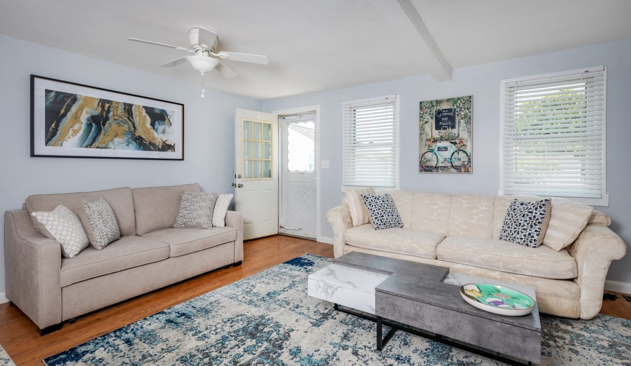 a living room with two couches and a coffee table.