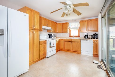 a white refrigerator freezer sitting inside of a kitchen.