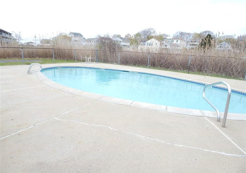 an empty swimming pool in a residential neighborhood.