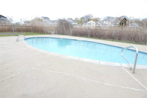 an empty swimming pool in a residential neighborhood.