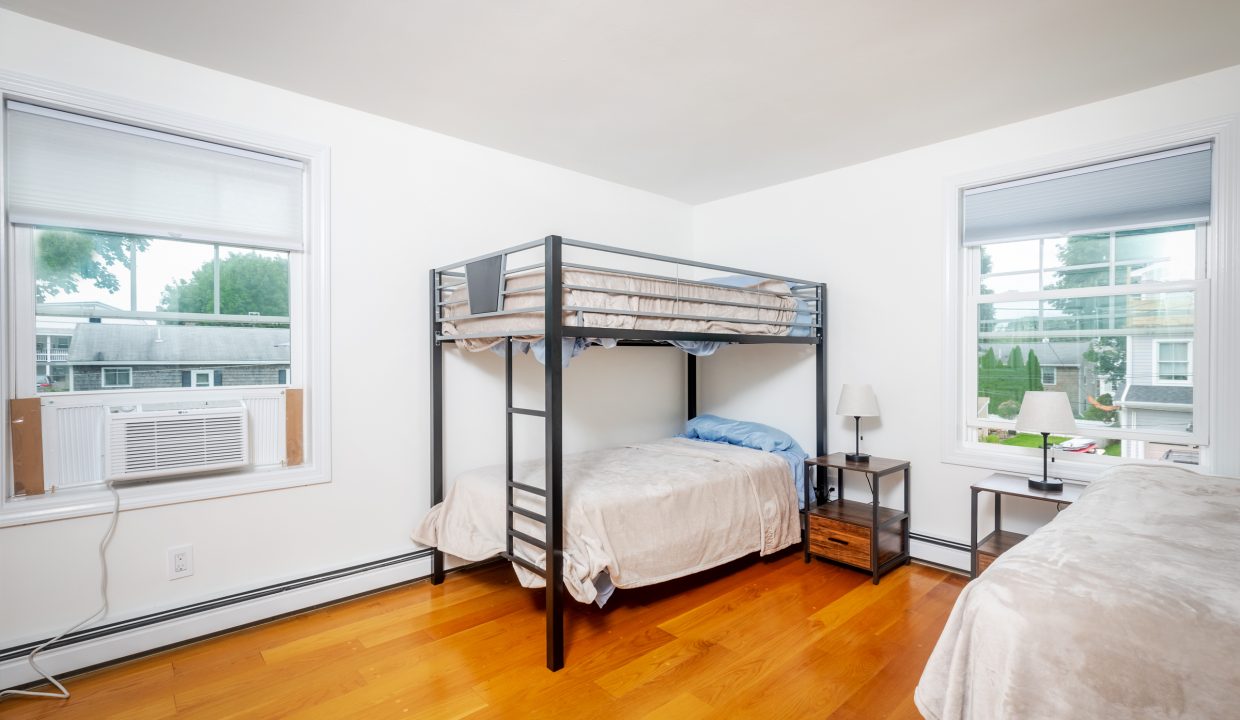 A room with two bunk beds and a window.