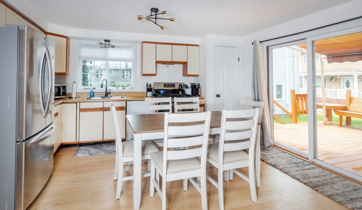 A kitchen with a table and chairs.