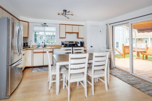 A kitchen with a table and chairs.