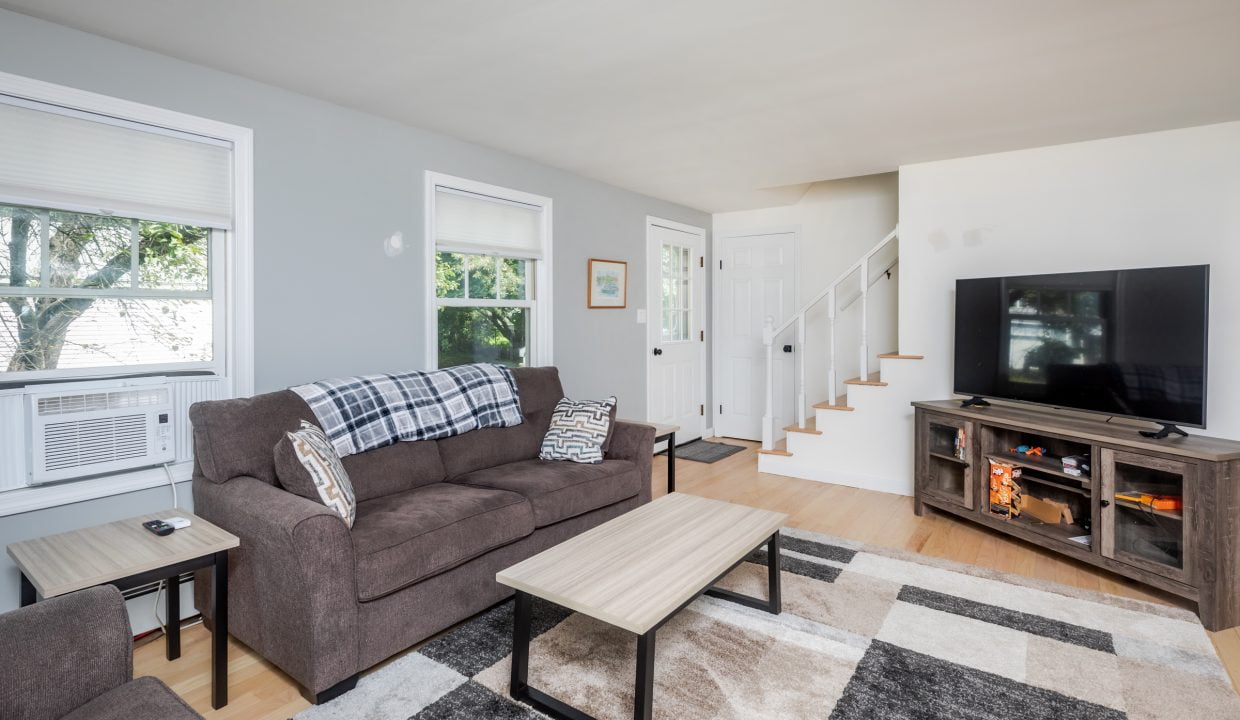 A living room with couches and a tv.