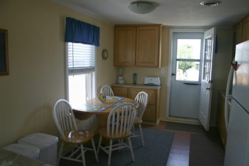 A small kitchen with a table and chairs.