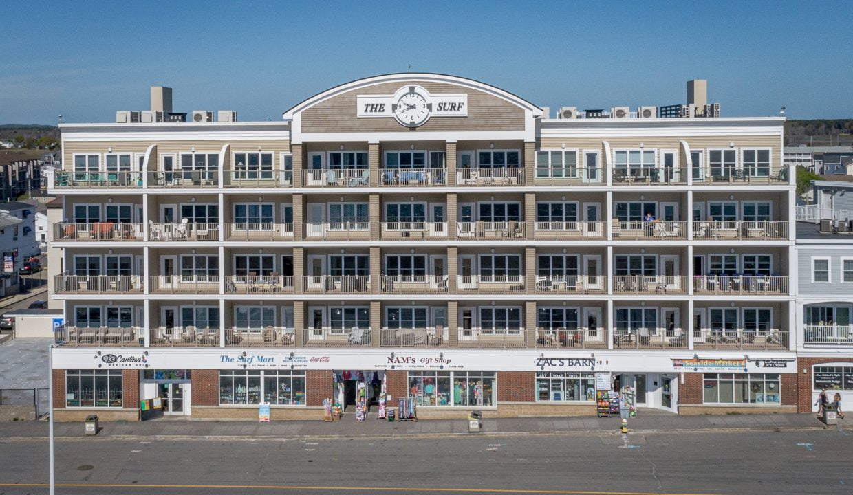 An aerial view of an apartment building on the beach.