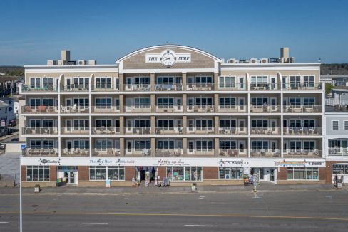 An aerial view of an apartment building on the beach.