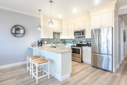 A kitchen with white cabinets and stainless steel appliances.