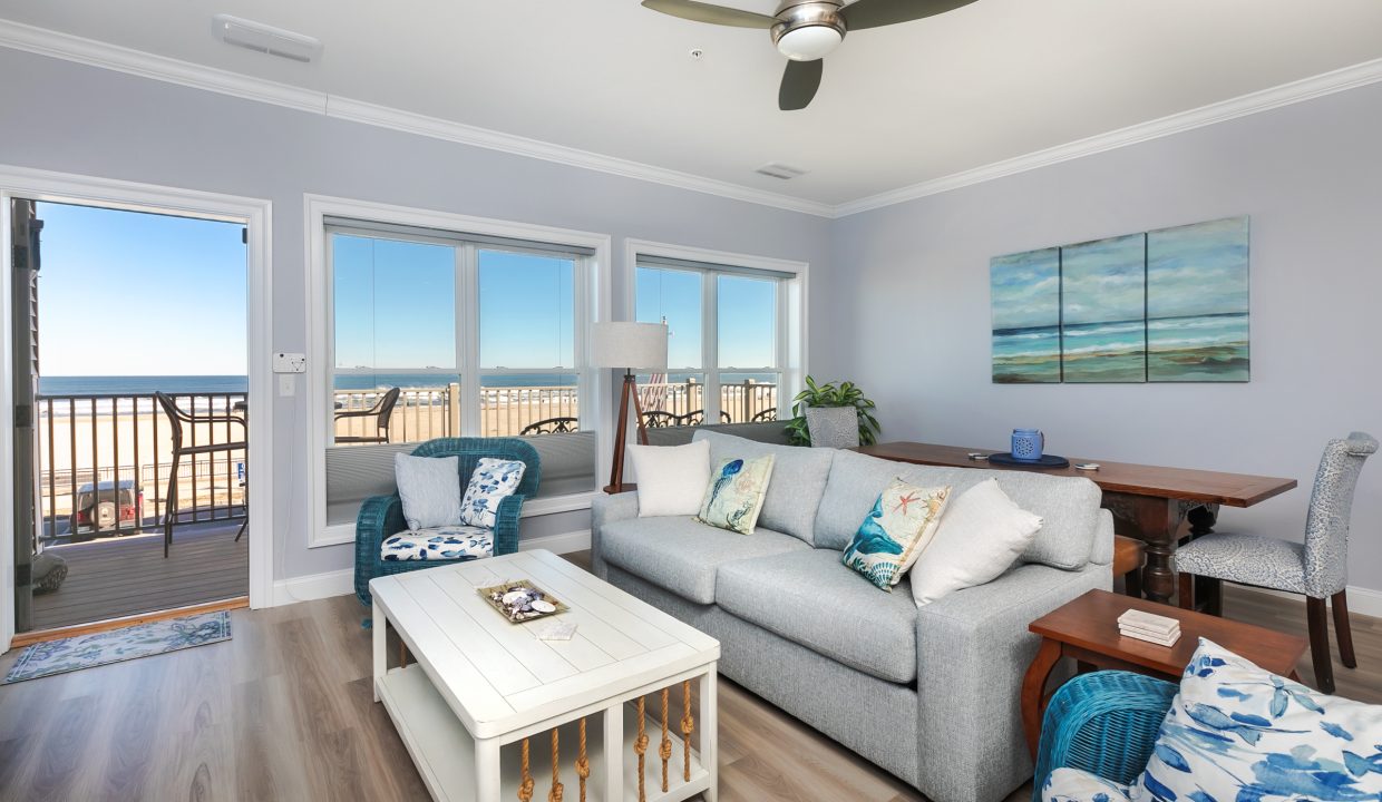 A living room with a view of the ocean.