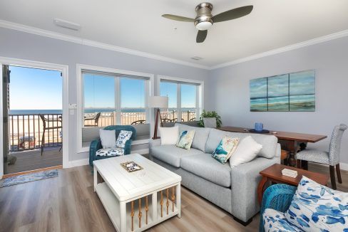 A living room with a view of the ocean.