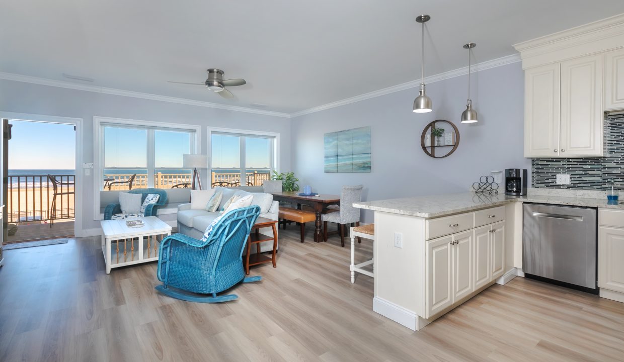 A kitchen and living room with a view of the ocean.