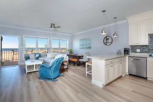 A kitchen and living room with a view of the ocean.